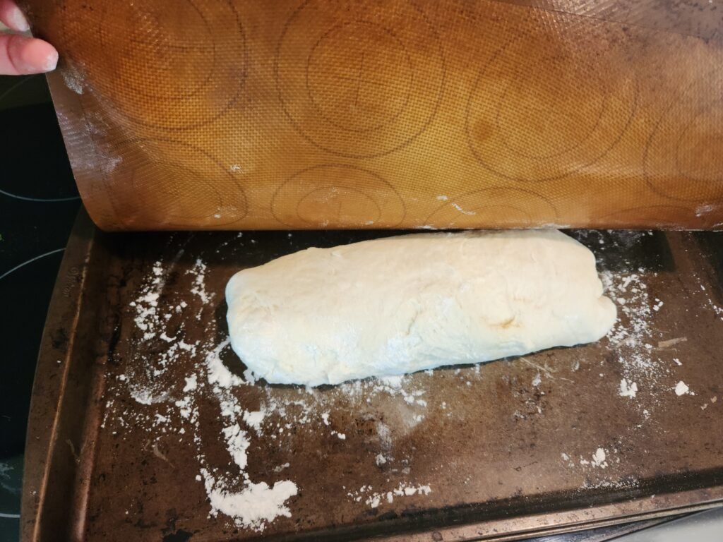 Placing loaf on floured baking sheet