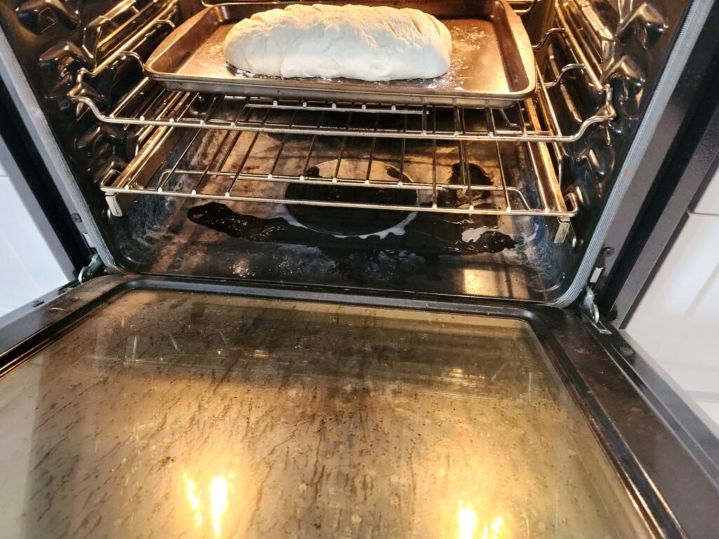 Bread placed into oven and a 1/4 cup of water poured onto bottom of oven.