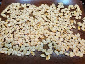 pumpkin seeds on baking sheet.