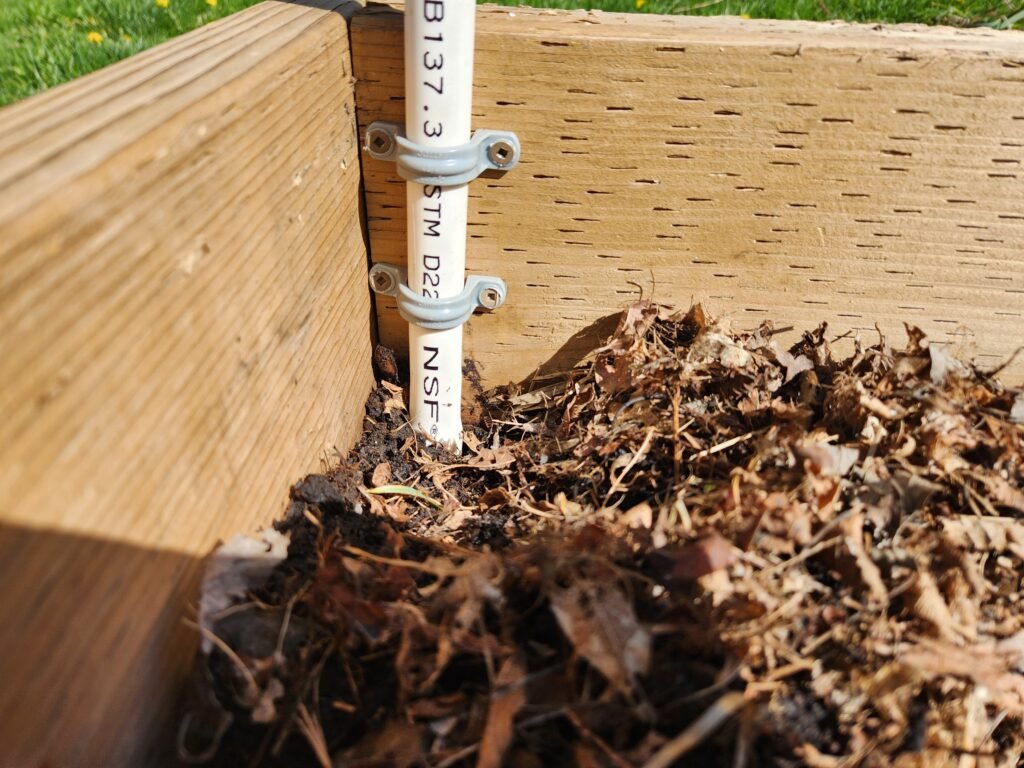 PVC pipe attached to garden bed