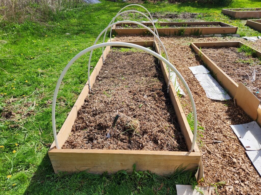 Raised garden bed with PVC hoops