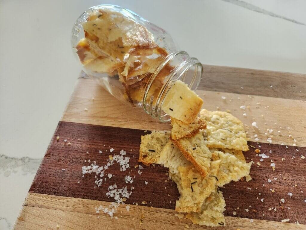 Sourdough crackers spilling from jar