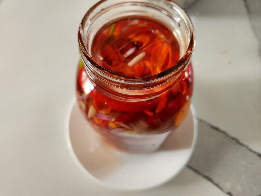 Brine filled to top of mason jar for fermenting.