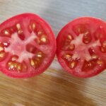 Tomato cut in half to remove tomato seeds