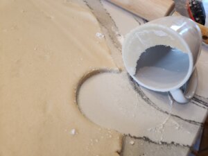 Cutting out crescent moon shapes into kourabiedes dough