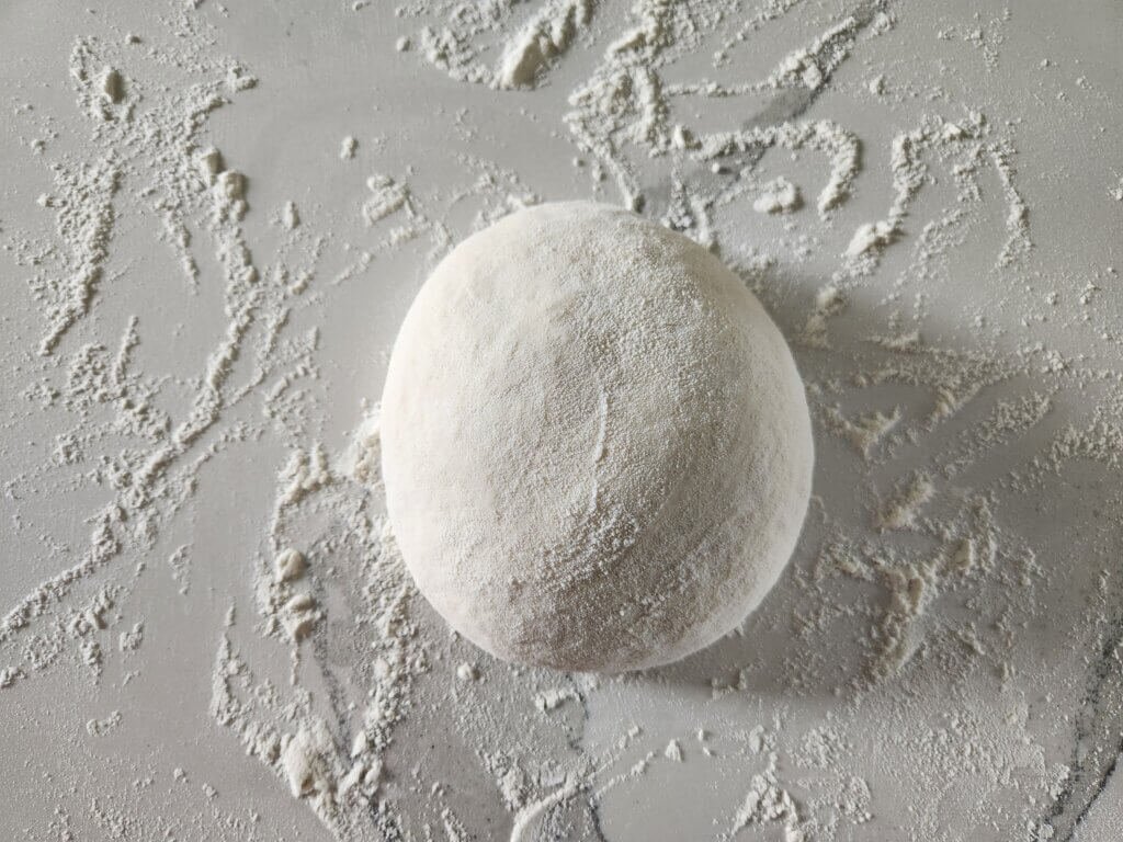 Fresh soft bread dough kneaded into a smooth ball