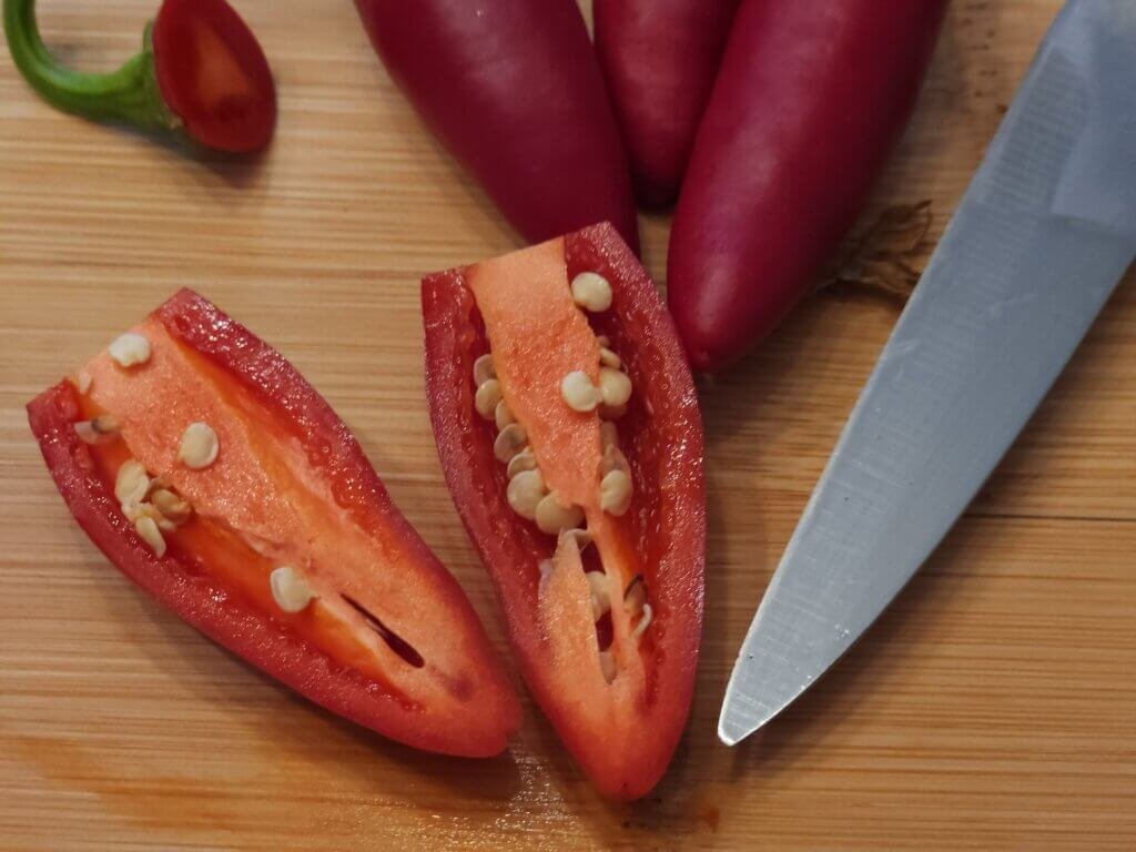 Jalapeno pepper cut in two to show viable pepper seeds