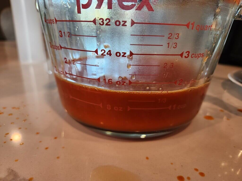 Measuring cup with finished hot sauce