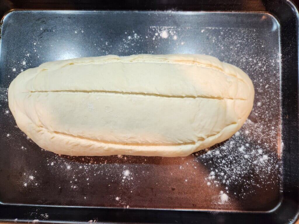 Scored fresh bread dough ready for baking