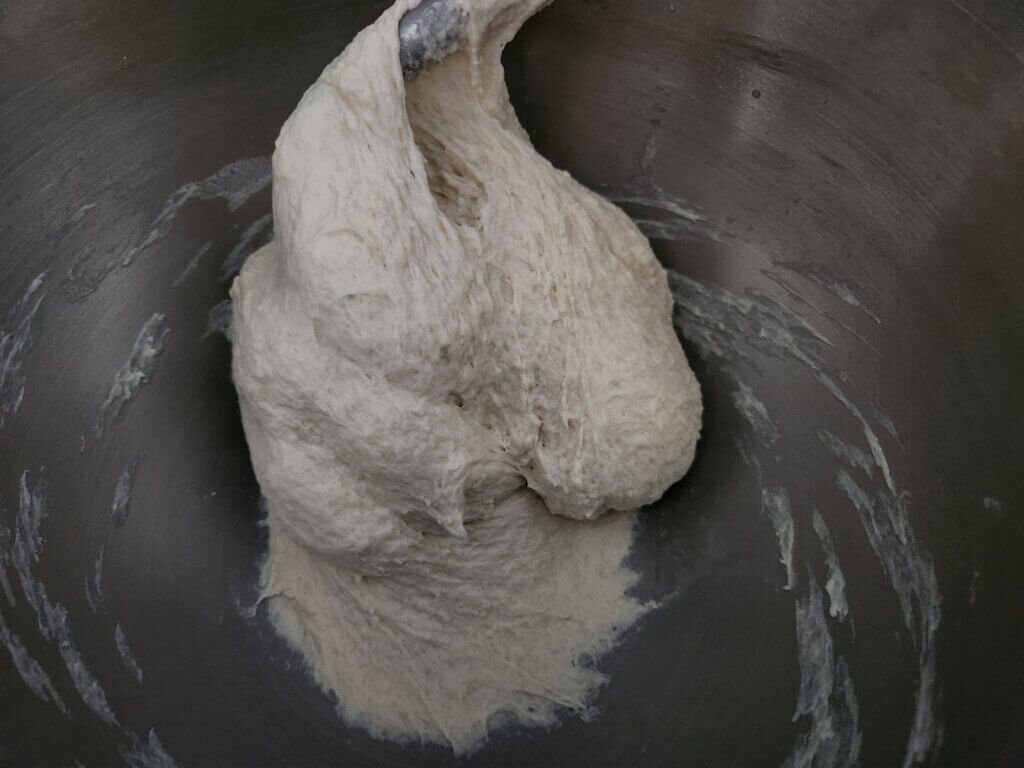 Soft bread dough fully combined in stand mixer