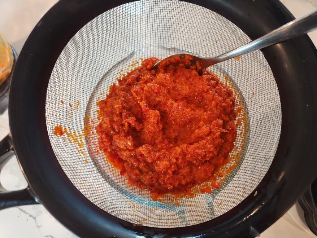 Straining fermented hot sauce mash
