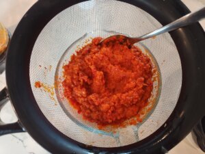 Straining fermented hot sauce mash
