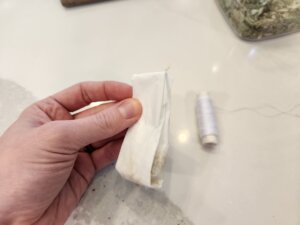 First fold of the top down of the teabag