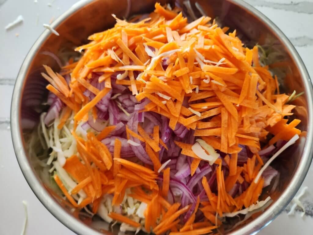 Fresh shredded carrots added to homemade coleslaw