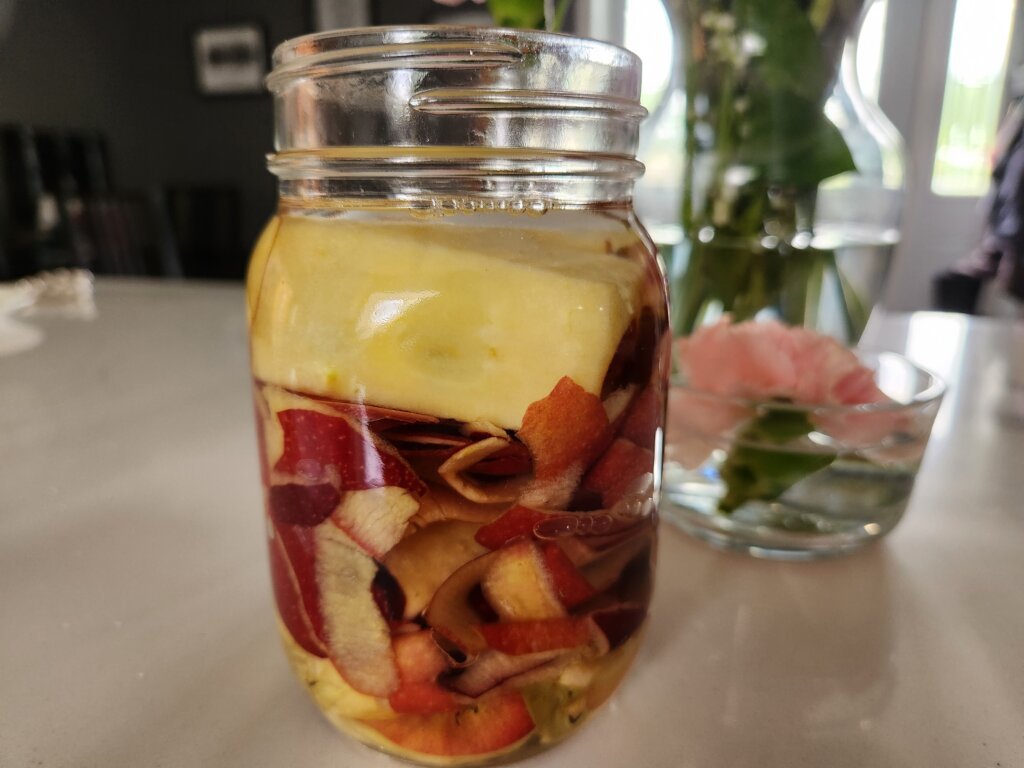 Apple scraps and water with sugar combined into jar