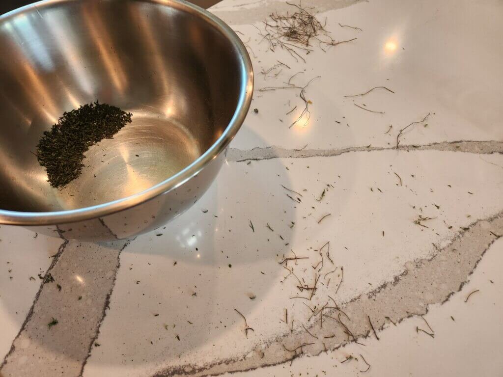 Dried Thyme in a Bowl and Stems All Around The Counter