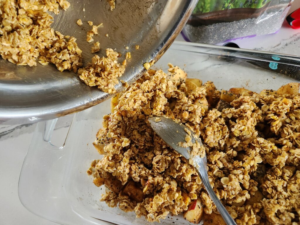 Adding Granola Topping to Apple Crisp