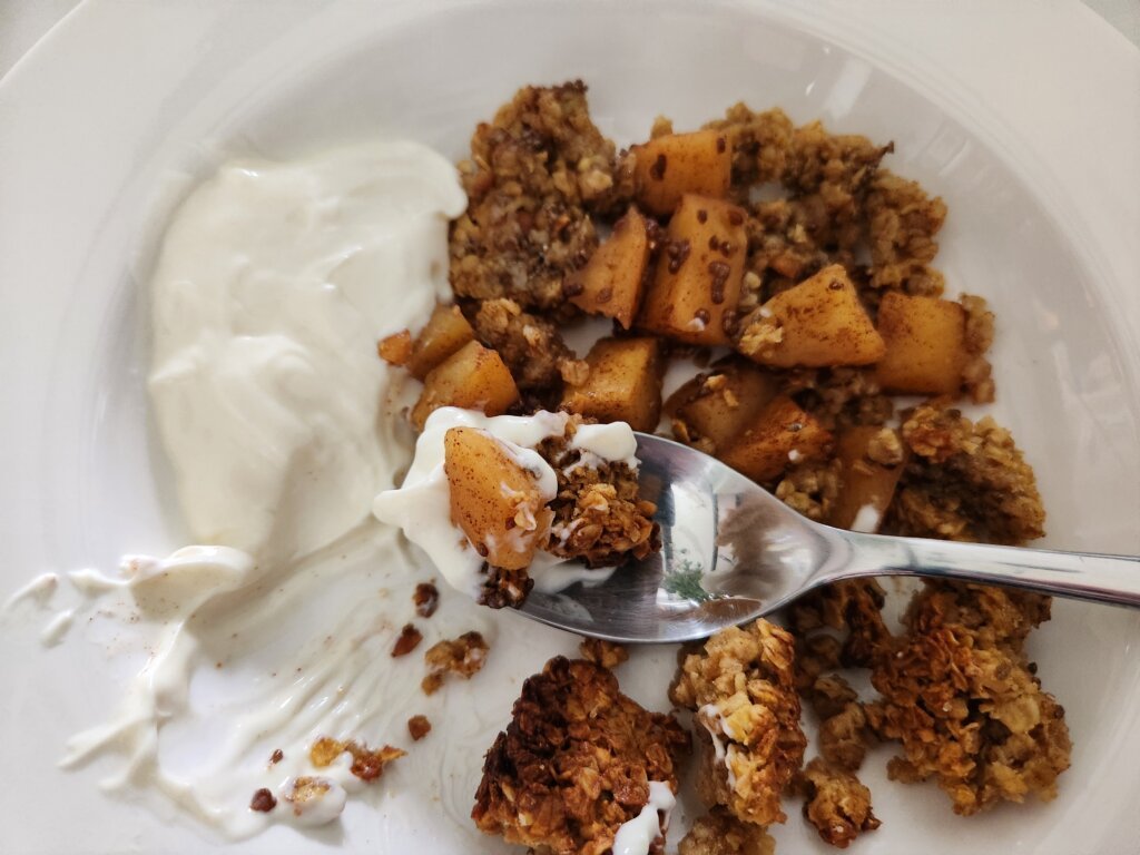 Apple Crisp with Granola Topping and Yogurt on a Spoon
