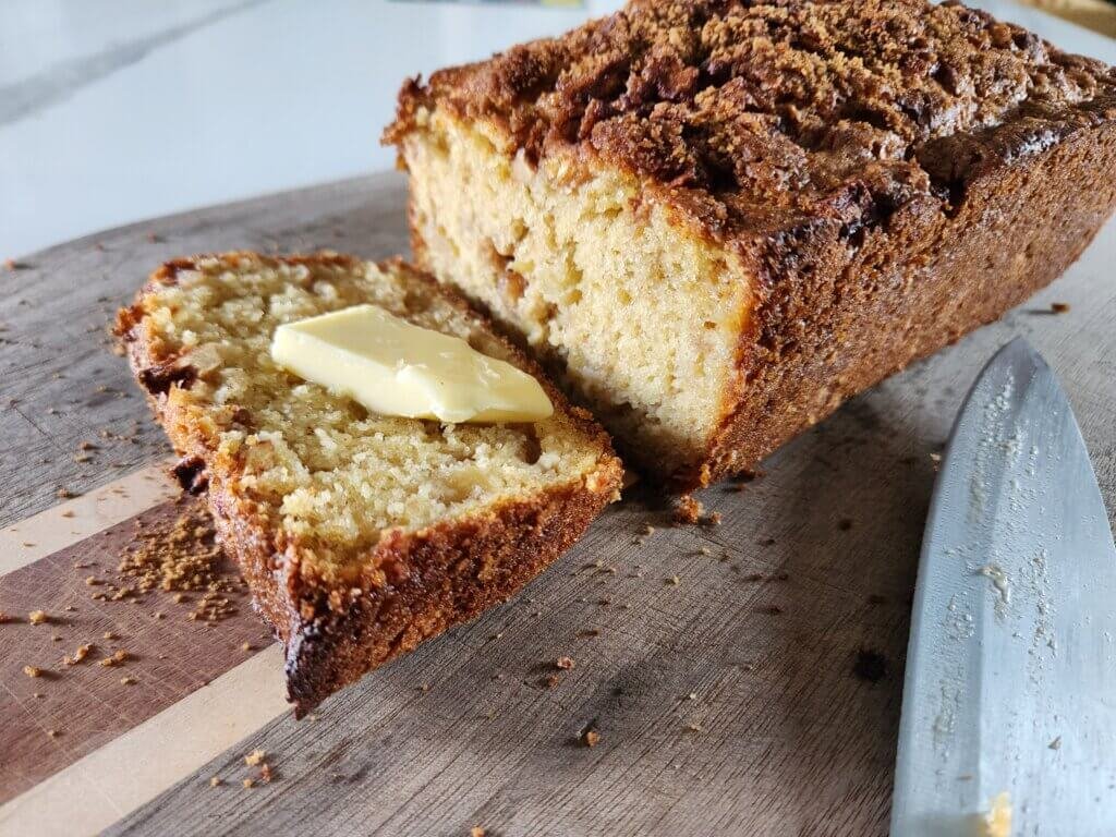apple fritter bread freshly cut with a slice of butter