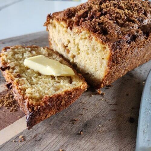 apple fritter bread freshly cut with a slice of butter