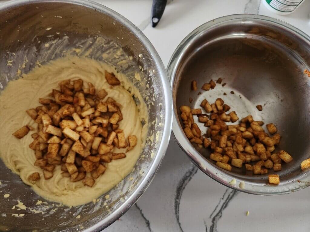 two thirds of apples mixed in with the apple fritter bread batter