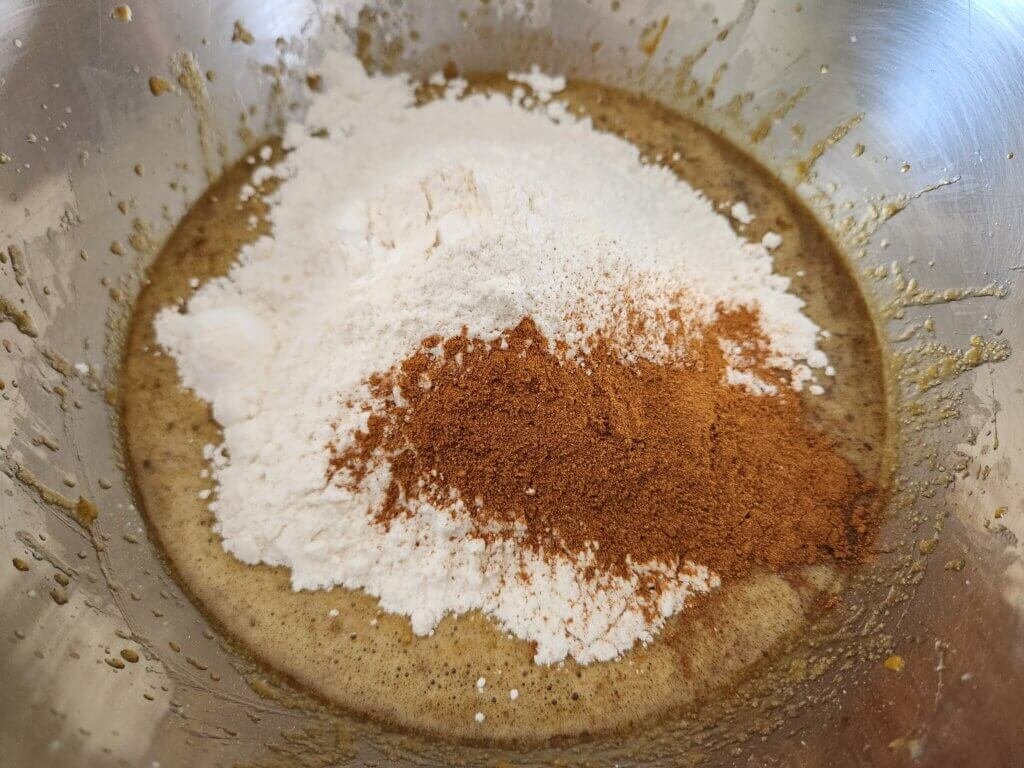 Adding dry ingredients to pumpkin spice cookies