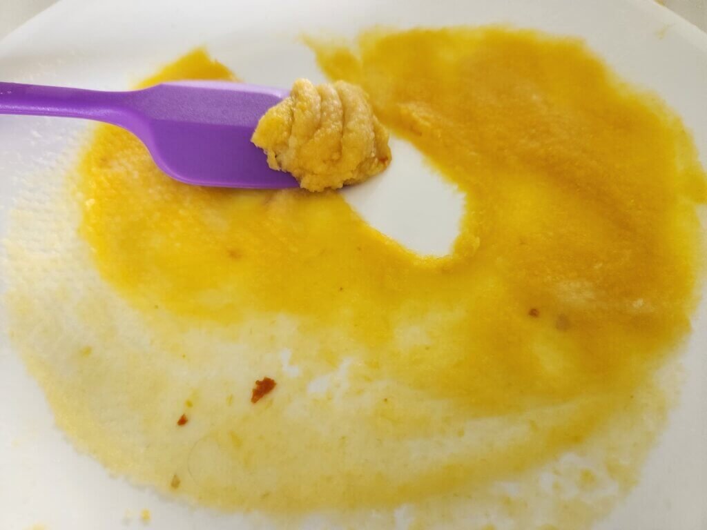 Pumpkin puree after excess moisture has been removed with paper towel, showing the thick consistency needed for pumpkin spice cookies.
