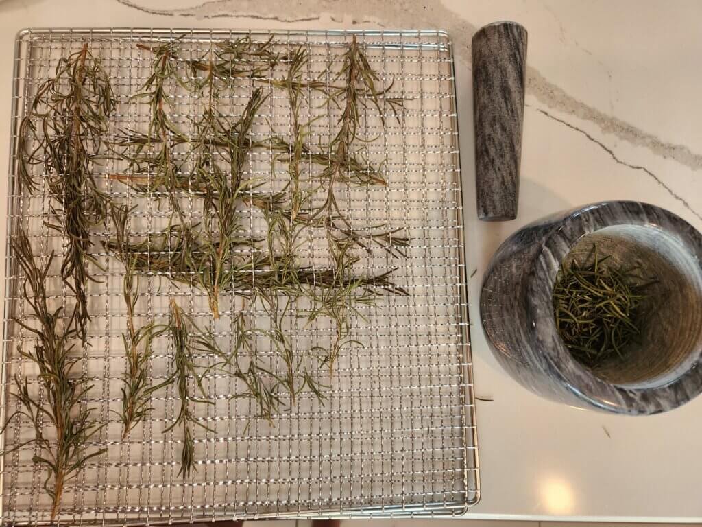 Rosemary Dried on Dehydrator Tray and Ground Up in Mortar