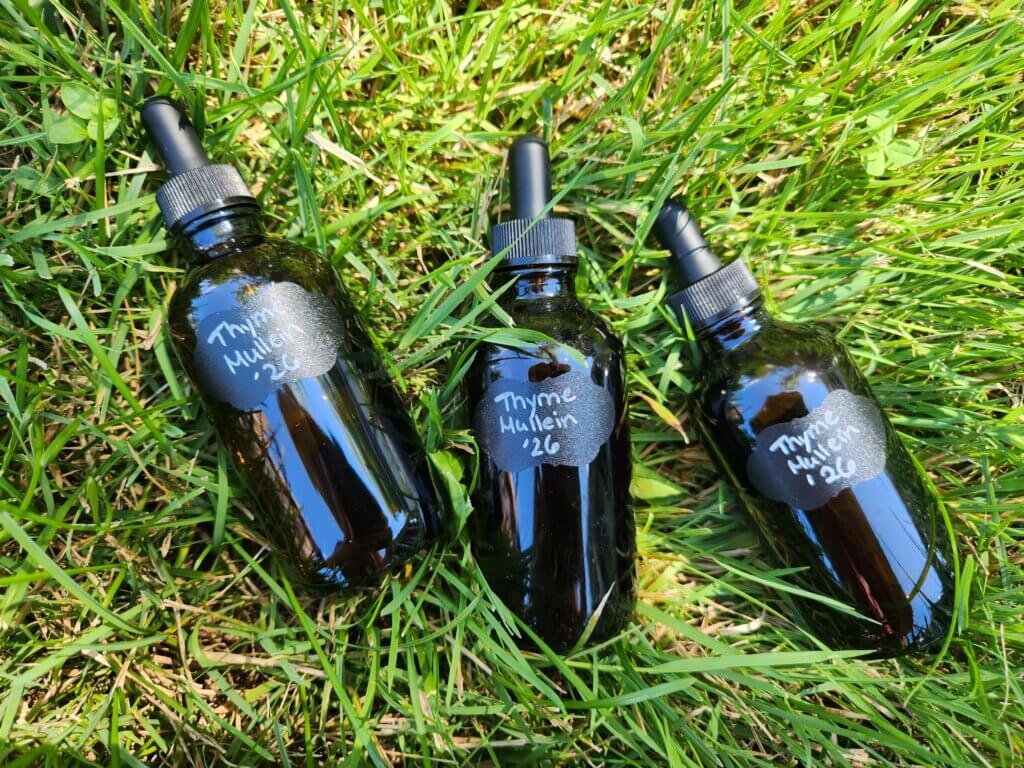 three tincture bottles in the grass