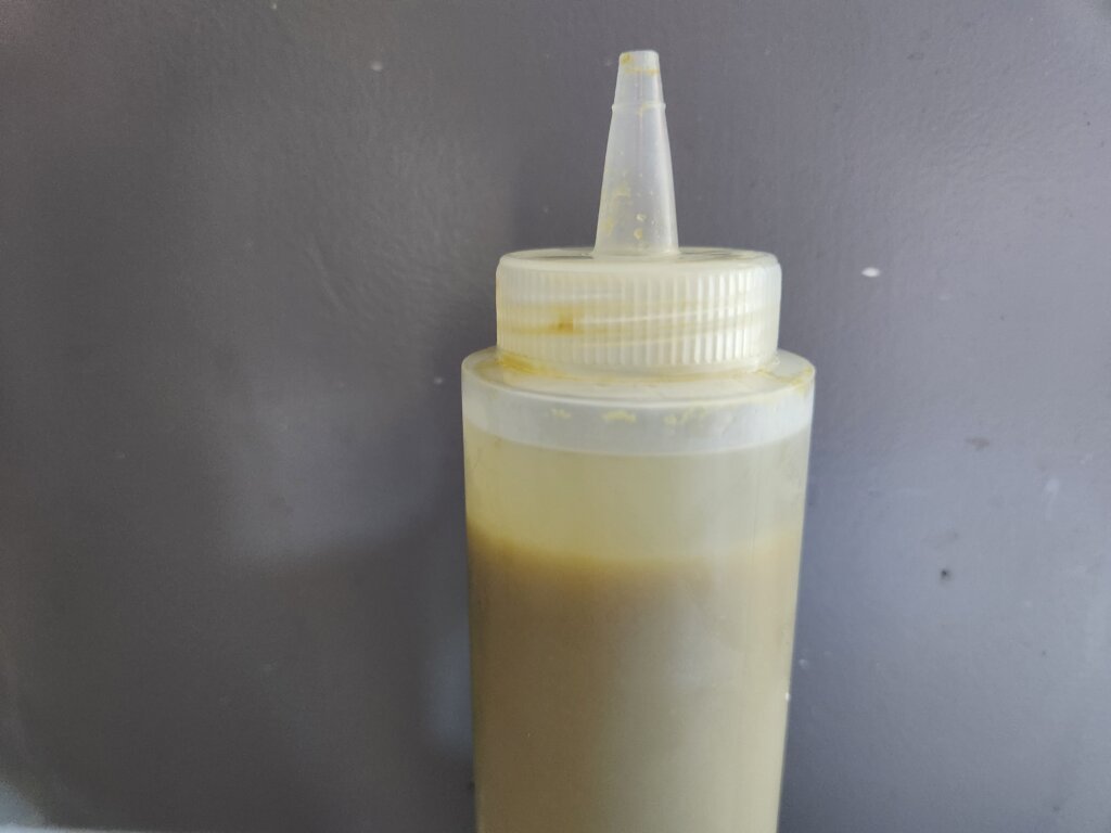 Fermented jalapeño hot sauce separating in a squeeze bottle