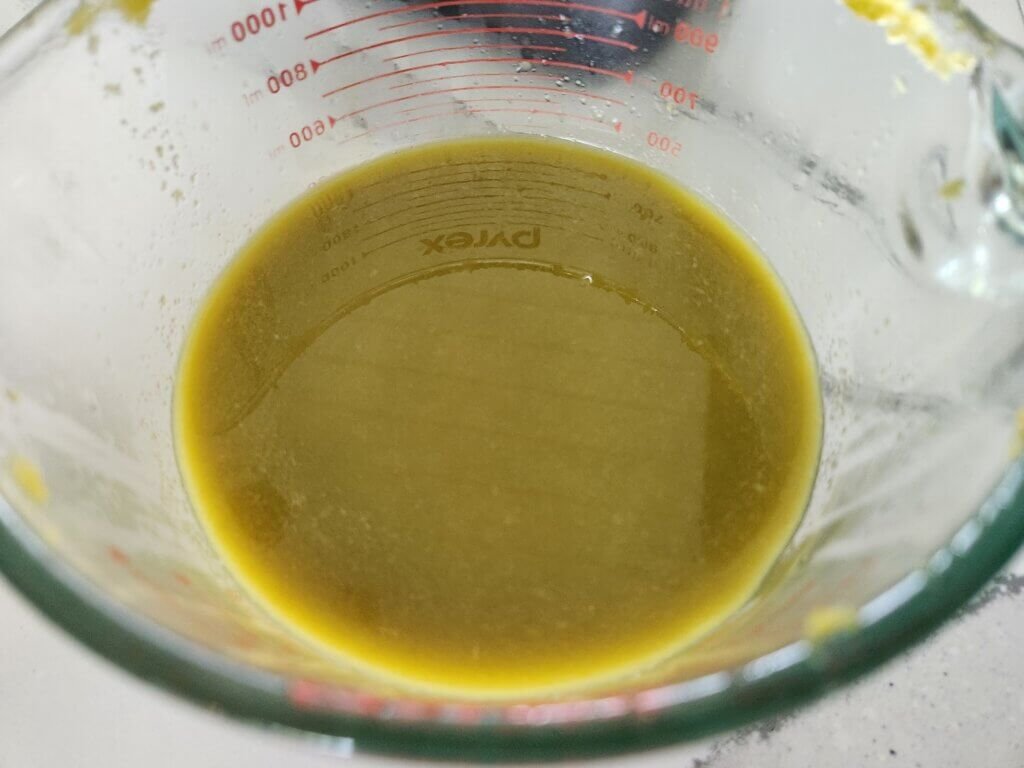 Strained fermented jalapeño hot sauce ready for bottling